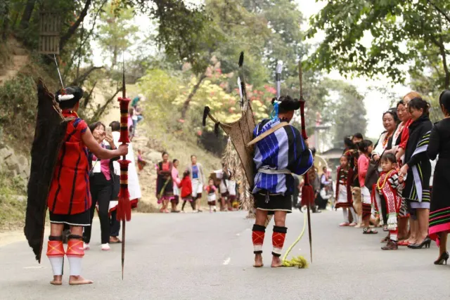 An Angami Brave adorned in tribal finery going to the festival