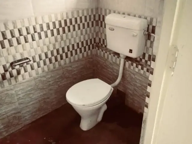 Attached bathroom with a western toilet in the homestay