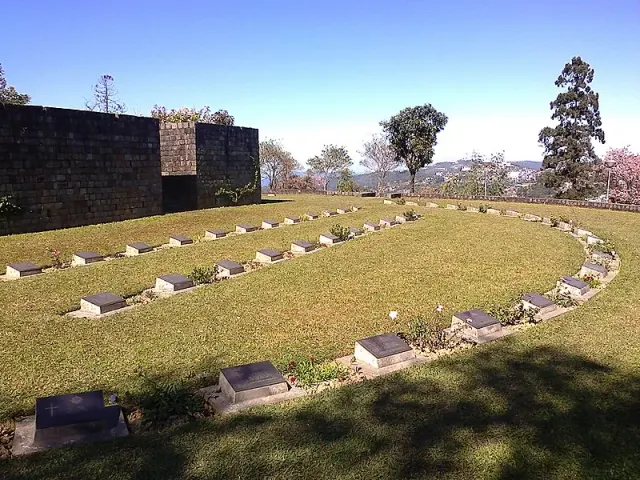The Kohima War Cemetery with its rows of stone markers on a sunny day